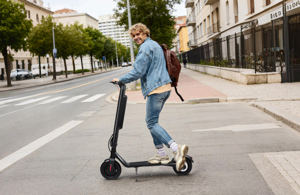 Person riding an electric scooter on a city street